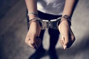 juvenile criminal in handcuffs