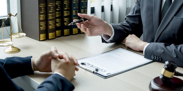 Lawyer hand holding pen and providing legal consult business dispute to the man